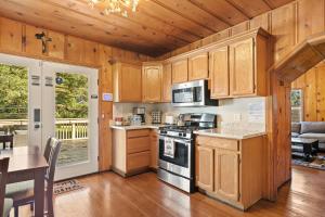 a kitchen with wooden cabinets and a stove top oven at SPSL Lake Arrowhead llc in Lake Arrowhead