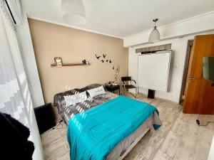 a bedroom with a bed and a white screen at Mini departamento LUMIC II in Santa Fe