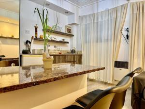 a kitchen with a counter and chairs in a room at Mini departamento LUMIC II in Santa Fe +5 photos