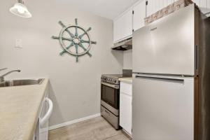 a kitchen with a refrigerator and a sink at Cedar Haven Unit 202 by Simple Life Rentals in Ephraim
