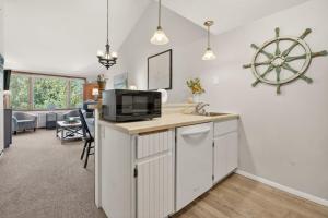 a kitchen with a sink and a microwave at Cedar Haven Unit 202 by Simple Life Rentals in Ephraim