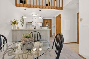 a dining room and kitchen with a glass table and chairs at Cedar Haven Unit 202 by Simple Life Rentals in Ephraim +36 photos