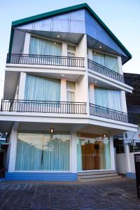a tall building with windows and a balcony at The Thekkady Haritham Residency in Thekkady