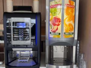a pay phone and a drink vending machine at Ibis Budget Ancenis in Mésanger
