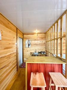 a log cabin with a sink and a table at Villa Celyn Dieng cabin in Diyeng