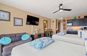 a living room with two beds and a couch at Ocean View 2 Queen Studio at Landmark Resort in Myrtle Beach
