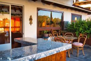 a patio with a table and chairs and a table at Finca del Valle in Valle de Bravo