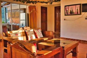 a living room with a couch and a table at Finca del Valle in Valle de Bravo +13 photos