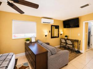 a living room with a couch and a table at Private Guest Suite with Separate Entrance & Kitchen in Lauderdale Lakes