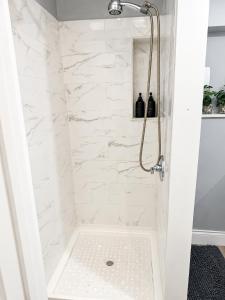 a bathroom with a shower with white marble at Private Guest Suite with Separate Entrance & Kitchen in Lauderdale Lakes
