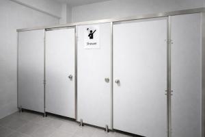 a row of four white lockers with a sign on them at YT Hotel & Hostel Vientiane in Vientiane
