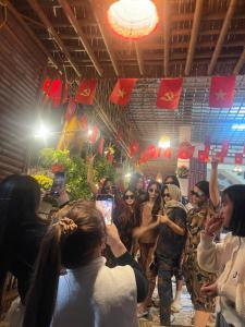 a group of people taking pictures with their cell phones at Hang Mua Bungalow in Ninh Binh