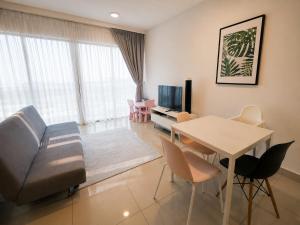 a living room with a couch and a table at Minimalist Studio Trefoil Setia Alam linked bridge to Mall and Convention Centre near to NIH Peninsula in Setia Alam