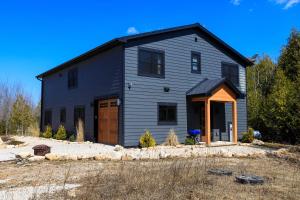 a gray house with a gambrel roof at Flint Ridge in Sister Bay
