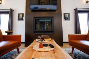 a living room with a wooden table and a fireplace at Flint Ridge in Sister Bay