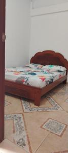 a bed sitting on top of a tile floor at Apartamento Brisa y Mar 2 in Arboletes