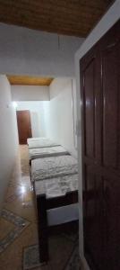 a room with three beds in a room with a door at Apartamento Brisa y Mar 2 in Arboletes
