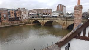 a bridge over a river in a city at Lil's On The Waterfront in York