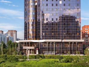 a tall building in a city with buildings at Ibis Astana in Astana
