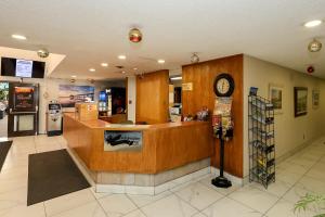 a store lobby with a counter and a clock at Confederation Inn Saskatoon in Saskatoon +31 photos