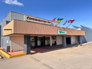 a building with a sign on top of it at Confederation Inn Saskatoon in Saskatoon