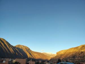 a view of the mountains and a city at hostal Balcon de Piedra in Urubamba