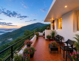 a balcony with a view of the mountains at Sterling Yercaud in Yercaud