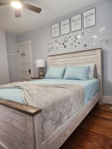 a bedroom with a large wooden bed with blue pillows at Peabody short term rental in Staunton
