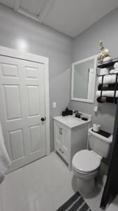 a white bathroom with a toilet and a sink at Peabody short term rental in Staunton +60 photos