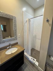 a bathroom with a sink and a shower at Granada Inn in Granada Hills