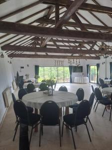 a dining room with a large table and chairs at Conacul Elenei in Poiana Mărului