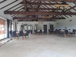 a large room with tables and chairs in it at Conacul Elenei in Poiana Mărului