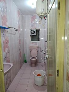 a bathroom with a toilet and a sink and a shower at SEYONE stay in Kanchipuram