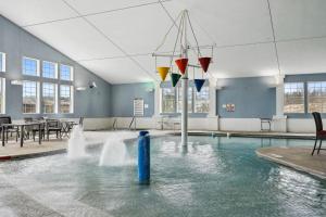 a pool with a fountain in the middle of a building at La Dolce Vita in Egg Harbor