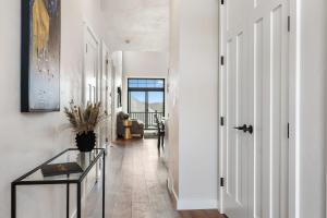 a hallway with white walls and a glass table at La Dolce Vita in Egg Harbor