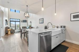 a kitchen with white cabinets and a sink and a table at La Dolce Vita in Egg Harbor +43 photos