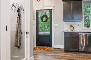 a kitchen with a black door and a counter at Stonehedge View by Simple Life Rentals in Egg Harbor