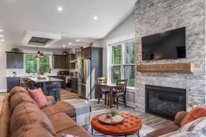 a living room with a couch and a fireplace at Stonehedge View by Simple Life Rentals in Egg Harbor +34 photos