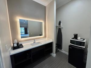 a bathroom with a sink and a mirror at Granada Inn in Granada Hills