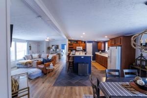 a kitchen and living room with a couch and a table at The Roost by Simple Life Rentals in Baileys Harbor +38 photos