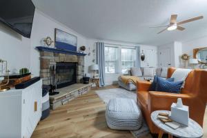 a living room with a couch and a fireplace at The Roost by Simple Life Rentals in Baileys Harbor
