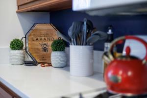 a kitchen counter with three plants in white cups at The Roost by Simple Life Rentals in Baileys Harbor