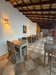 a dining room with wooden tables and chairs at Cantinho Centro Histórico in Paraty
