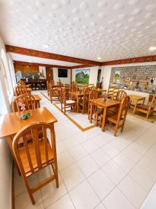 a dining room with wooden tables and chairs at Luz y Amistad - Pisac in Pisac