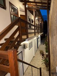 a stairway leading up to a building with wooden stairs at Cantinho Centro Histórico in Paraty