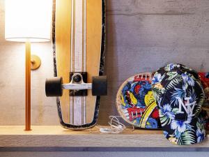 a skateboard sitting on a shelf next to a lamp at Ibis Budget Perpignan Sud in Perpignan