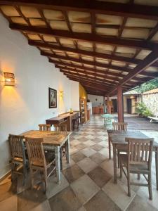 a dining room with wooden tables and chairs at Cantinho Centro Histórico in Paraty