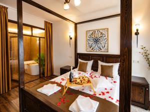 a bedroom with a large bed with flowers on it at Casa Dives - Varianta Boierească in Pianu de Sus