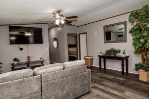 a living room with a couch and a ceiling fan at The Hidden Creek Hideaway in Huntsville