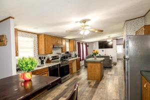 a large kitchen with wooden cabinets and a stainless steel refrigerator at The Hidden Creek Hideaway in Huntsville